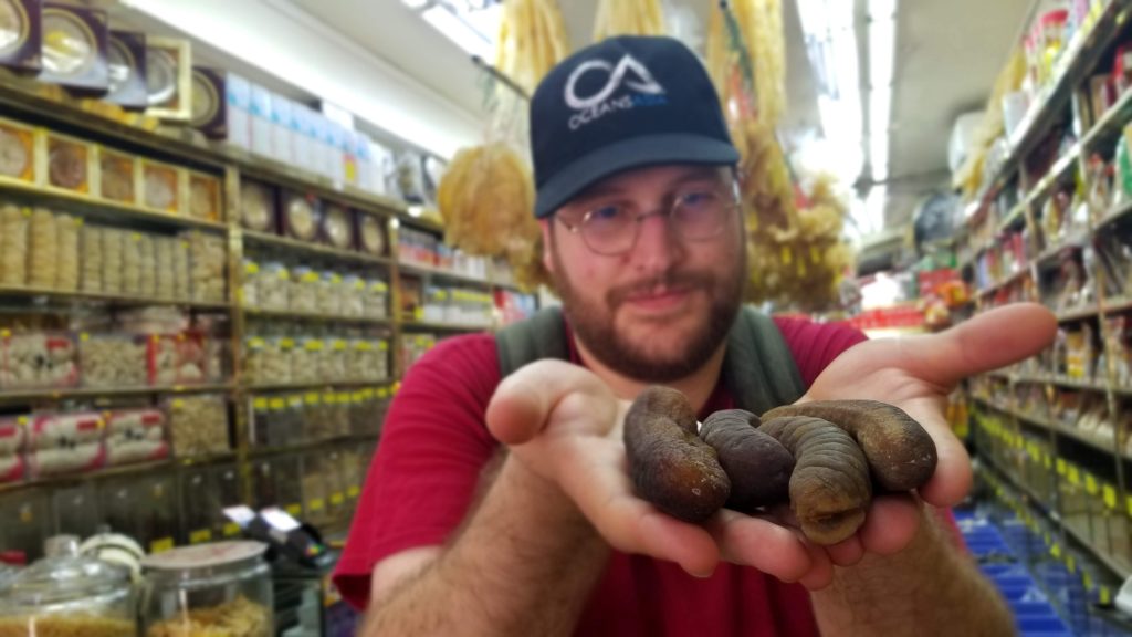 Dr. Teale Phelps Bondaroff with dried sea cucumbers in Singapore.