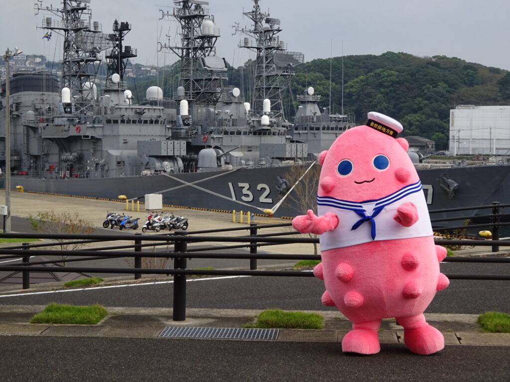 Namakoro, the mascot of the Japanese Marine Self-Defence Force in the Sasebo region (Southern Japan) in front of vessels.